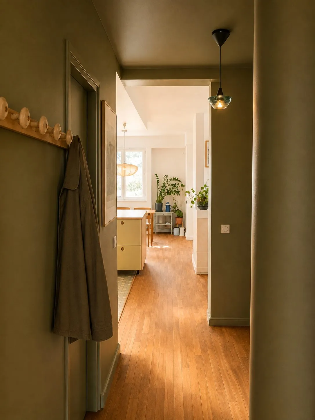 Couloir peint en vert olive ouvrant sur la cuisine